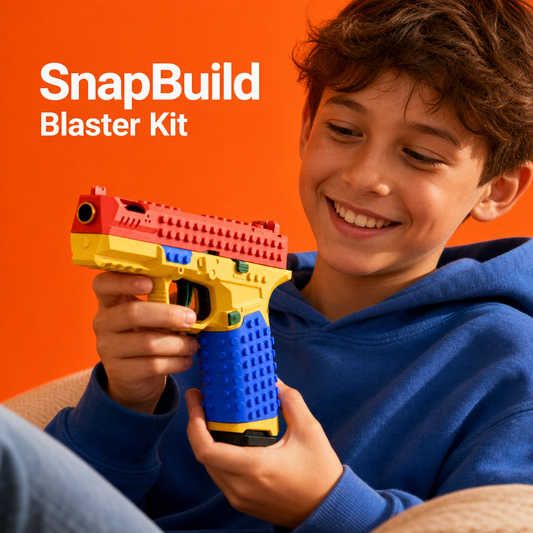 Smiling boy holding the red, yellow and blue SnapBuild brick blaster on an orange background